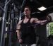 Strong muscular male athlete training with resistance band
